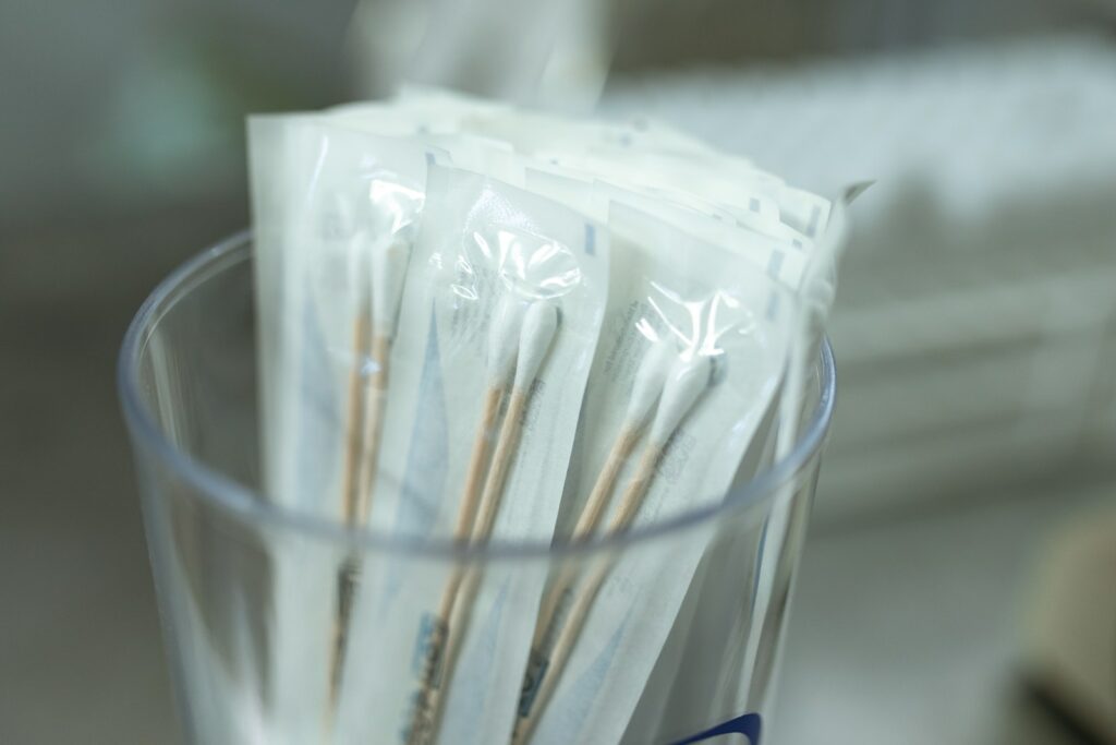 Close-up Photo of Glass of Cotton Swabs